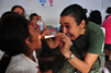 Brazilian navy physician from Rio de Janeiro, Brazil, examines a patient during a Continuing Promise 2011